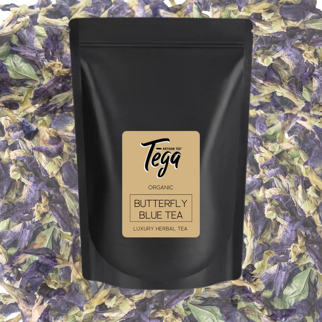 Black tea packaging with 'Tega' branding on a butterfly blue tea leaf background