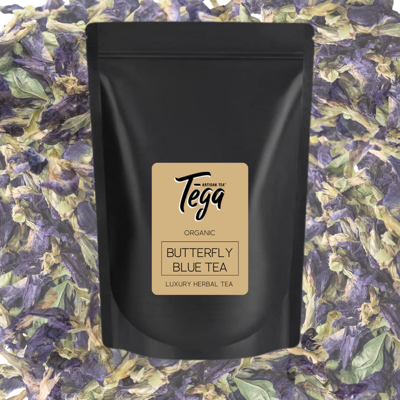 Black tea packaging with 'Tega' branding on a butterfly blue tea leaf background