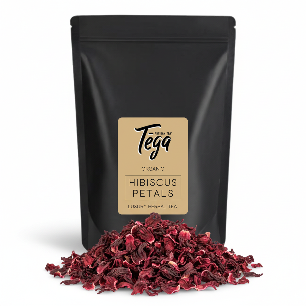 Black package of Tega Organic Hibiscus Petals with dried petals in front on a white background