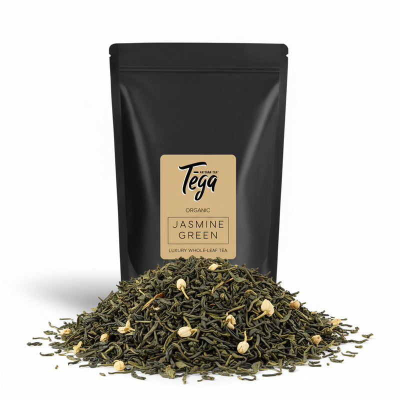 Tega Jasmine Green tea packaging with loose tea leaves on a white background